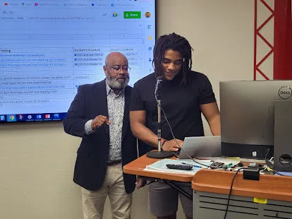 Reggie Dogan with a student at West Florida High School.