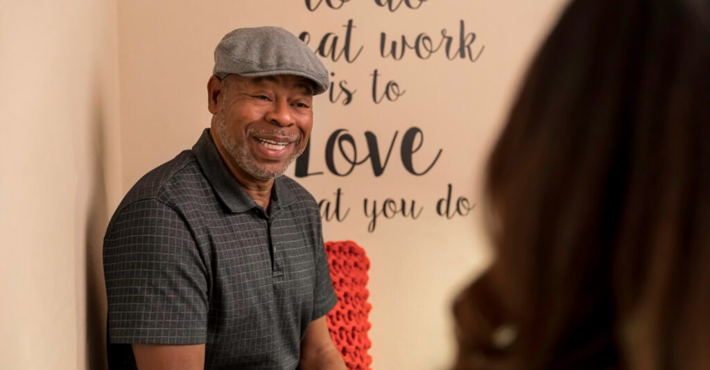 A man sits in an exam room at Community Health Northwest Florida.