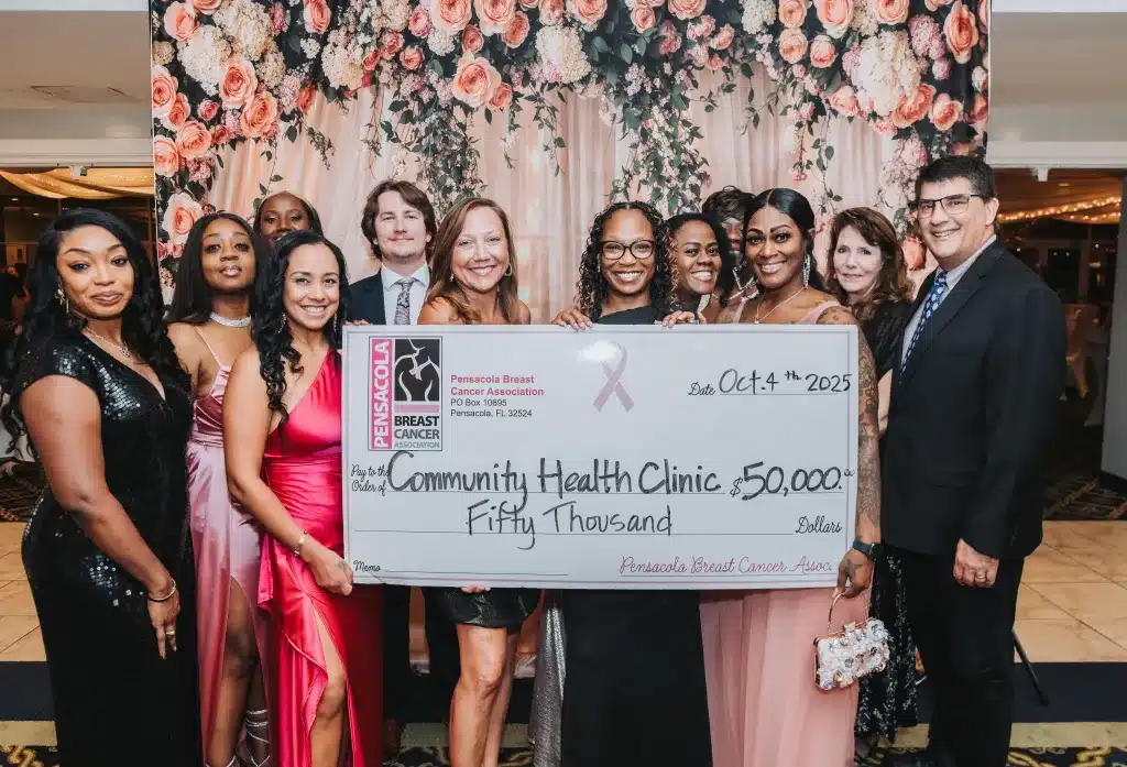 Members of Community Health Northwest Florida pose with a novelty check for $50,000 from the Pensacola Breast Cancer Association.