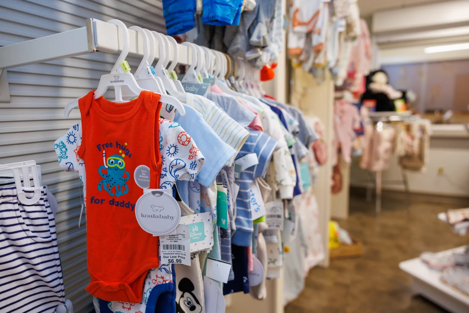 Toddler onesies in the Community Health Northwest Florida Baby Bucks store.