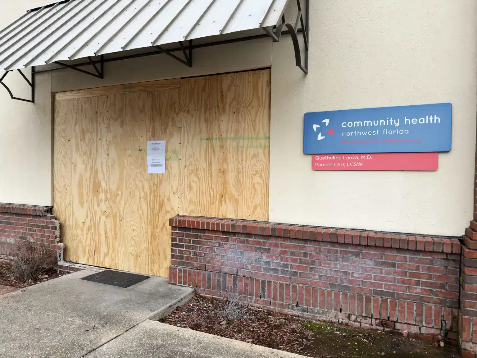 Plywood covering the doors of a building.