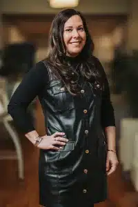 A woman in a black leather dress.