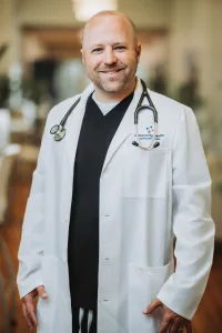 A professional portrait of Dr. Joel Geurin.