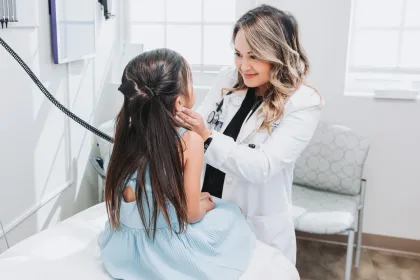 A doctor examines a pediatric patient at Community Health Northwest Florida.